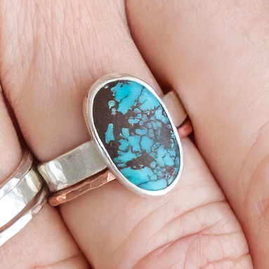 Oval Turquoise and Sterling Silver Ring with Hand-Hammered band. Shown styled with other rings and sold separately.