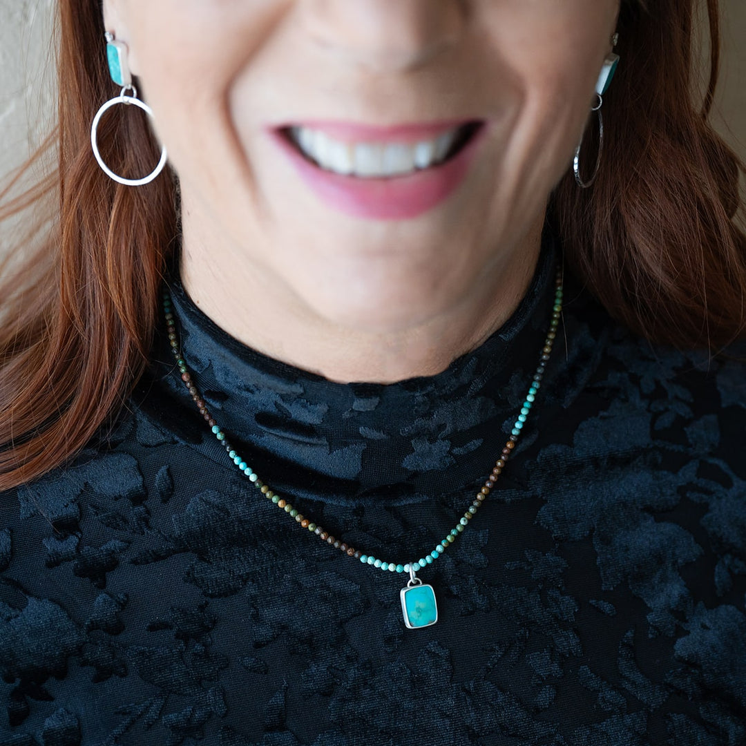 Turquoise beaded necklace with turquoise stone pendant. Set in sterling silver.