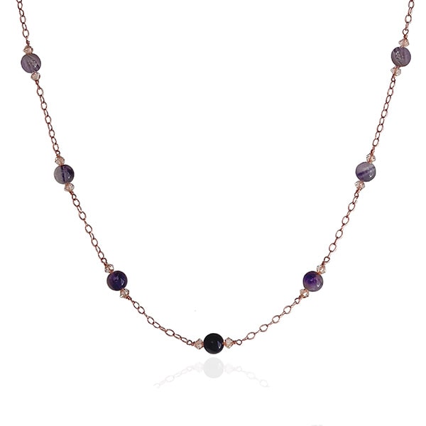 Make a glamorous statement with this stunning ombré-style necklace featuring natural Amethyst gems, Swarovski crystal golden shadow beads, and a 14Kt rose-gold filled chain. The unique design adds a flowing ombré pattern that captivates the eye. Perfect to add a touch of elegance to your everyday wardrobe. Modeled with matching earrings and a single pearl on a rose gold chain choker.