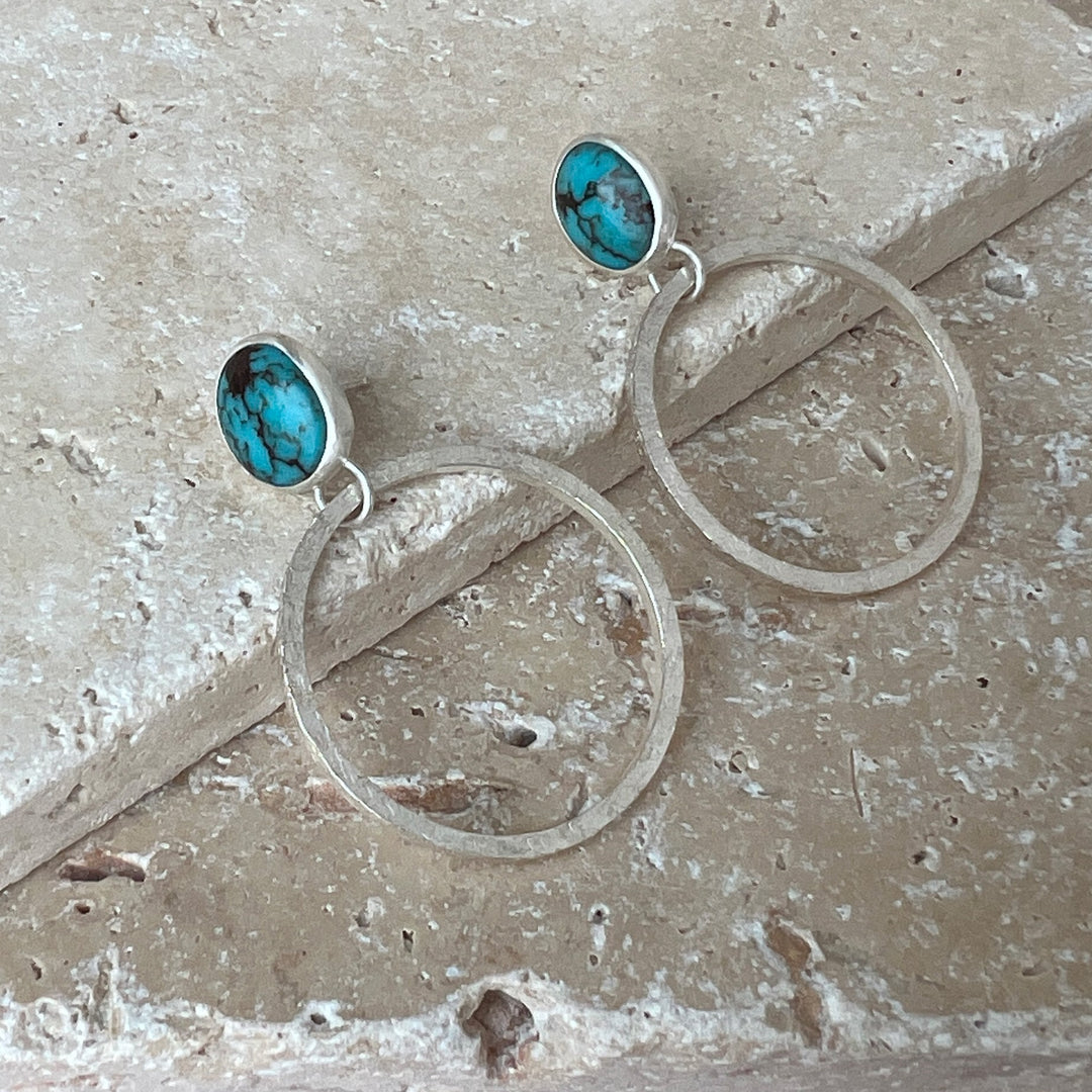 Medium-blue stones with a delicate spider web matrix. These linen-textured &amp; lightweight hammered hoops are a perfect earring for summer. Perfect to wear for summer or pack for your summer getaway.