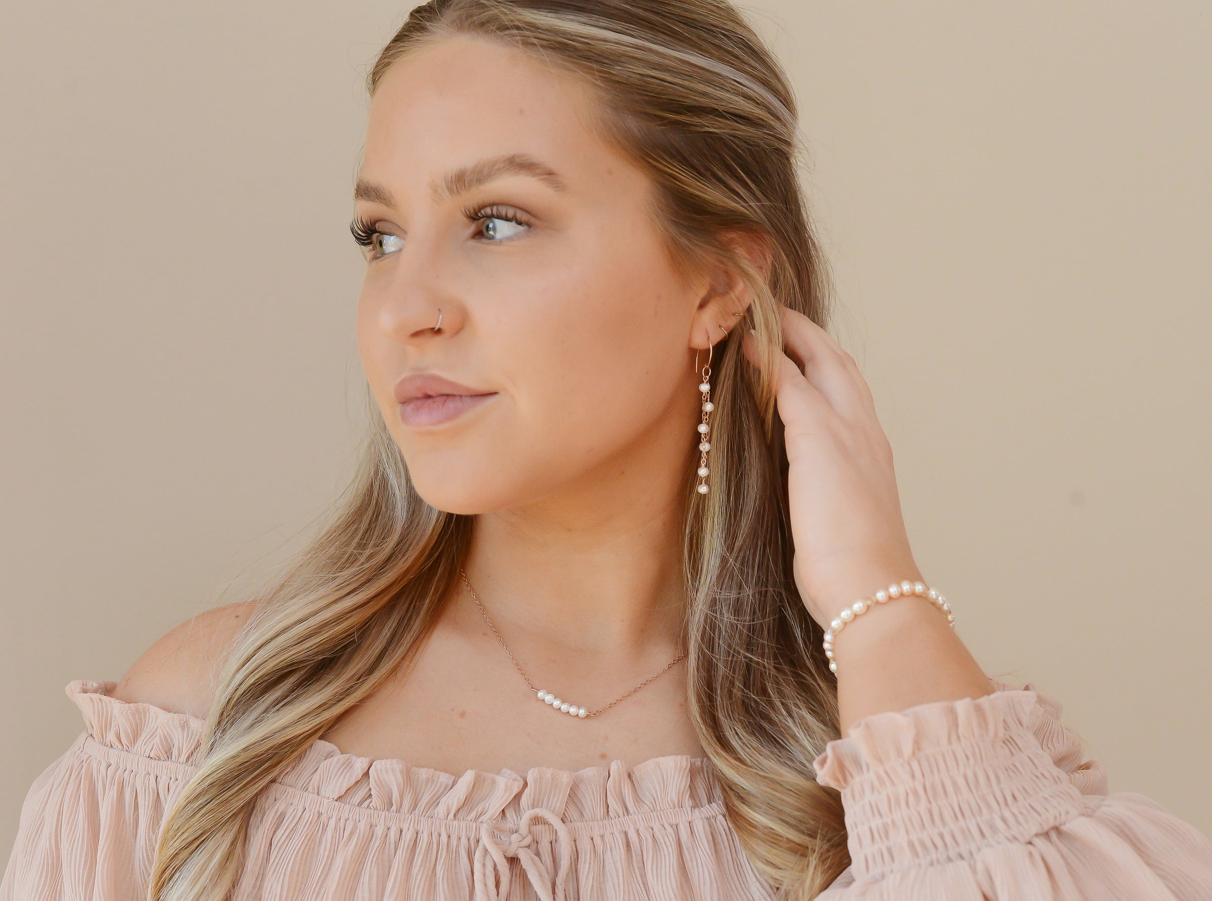 Jessica wearing 2-strand pearl earrings, pearl bar necklace and pearl bracelet. Rose Gold-filled metals and freshwater pearls.