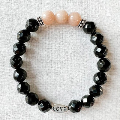 The Pinkflake Moonstone is known for its calming and harmonizing properties, while the Black Onyx brings strength and grounding to the design. The LOVE charm bead adds a touch of romance and affection to the bracelet, making it a perfect combination for those who want to feel balanced, empowered, and loved.