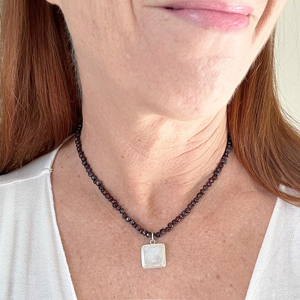 Rainbow Moonstone and rich red Garnet beaded necklace, set in sterling silver. 16 inches Worn on model Handcrafted in California by Novaura Jewelry
