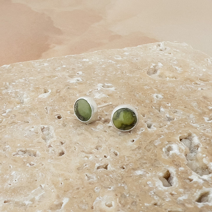 Small Turquoise and sterling silver round studs. Green color with brown matrix.
