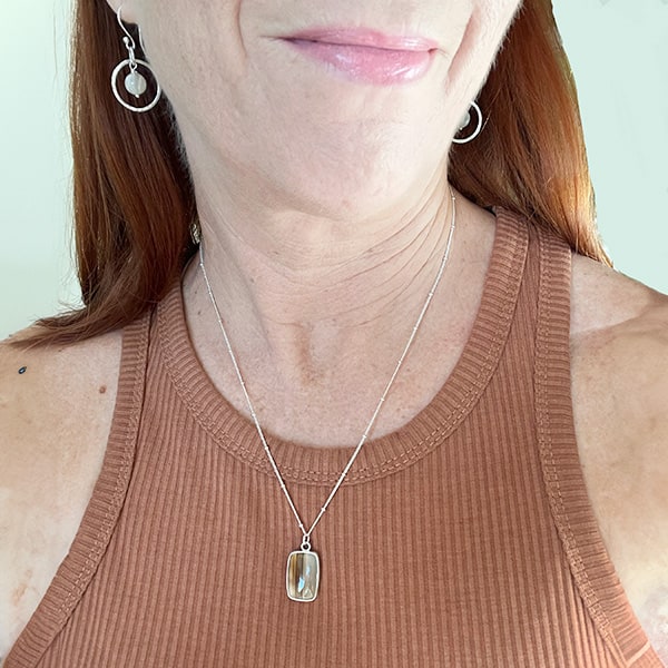 Moonstone Sterling Silver Hoops worn on  Shown worn with the Striped Montana Agate Necklace.