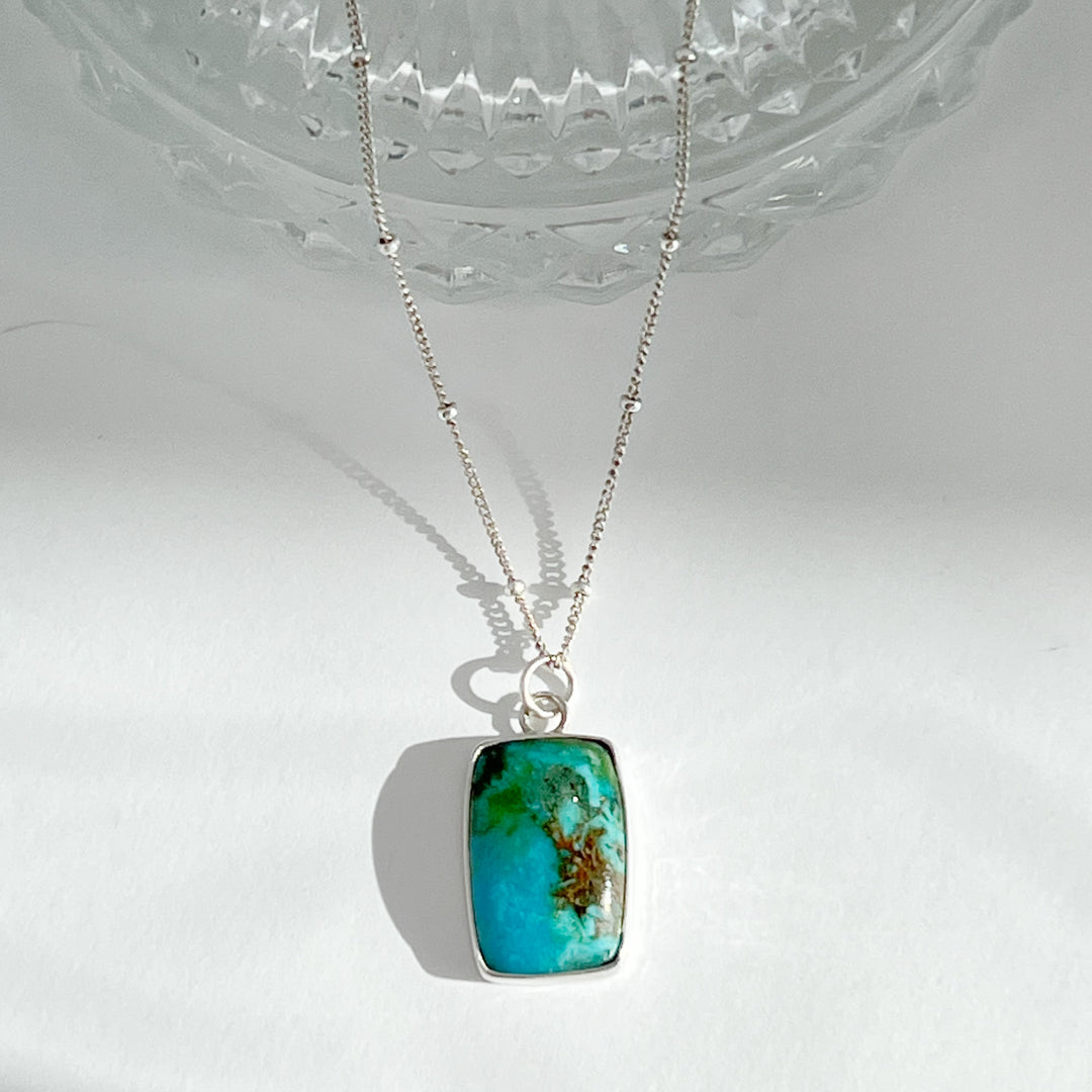 Show your adventurous spirit with this turquoise & sterling silver pendant necklace. Featuring an eye-catching natural turquoise pendant on an 18-inch sterling silver chain, this one-of-a-kind necklace will make sure you stand out from the crowd. Dare to be different!