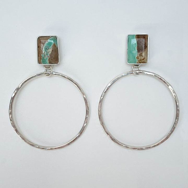 Turn heads with these one-of-a-kind Turquoise stud hoops, crafted with sterling silver and adorned with natural Royston Turquoise - mined in Nevada. The hammered texture of the hoops adds a touch of shimmer, while the stunning matrix of the turquoise exudes a southwestern charm. Handcrafted in California.