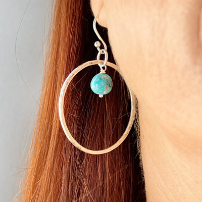 Turquoise and Sterling Silver large hoops shown worn.