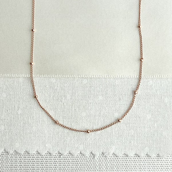 Add a delicate touch of femininity to your look with this beautiful 14kt rose gold-filled choker/ layering necklace. The necklace measures 16 inches, perfect for layering with other necklaces or wearing it alone for a more minimalist look. With its subtle and refined sparkle, it's a wonderful accessory to wear anytime, day or night.