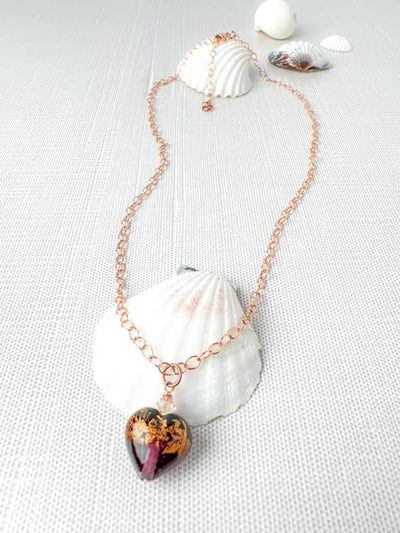 Adorn yourself with the romantic style of this Amethyst Murano glass heart pendant necklace. This exquisite piece features an Amethyst Murano glass heart bead with rich coverage of 24Kt gold foil in clear Murano glass which gives the bead a lovely depth. 