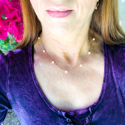 Inspired by the pearl and gold "gumball" necklace Madame VP- Kamala wears.  A faint golden-pink tone softens the white undertones of 6mm Swarovski crystal's light cream rose pearl, giving it a slightly vintage air. Laura modeling 6mm necklace.