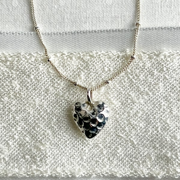 Fine silver heart necklace reveals the romantic & soft side of her personality. Looks lovely with all her sterling silver earrings. Simple and Beautiful Elegance.Heart Pendant detail.