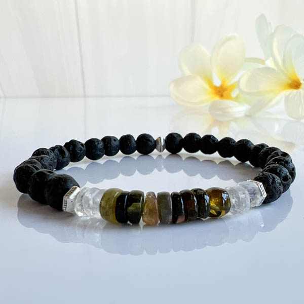 Heishi Shaped Tourmalines framed by Rainbow Moonstones highlight the translucent green and amber colors. Lava stone beads can absorb essential oil for relaxation. Reflected view.