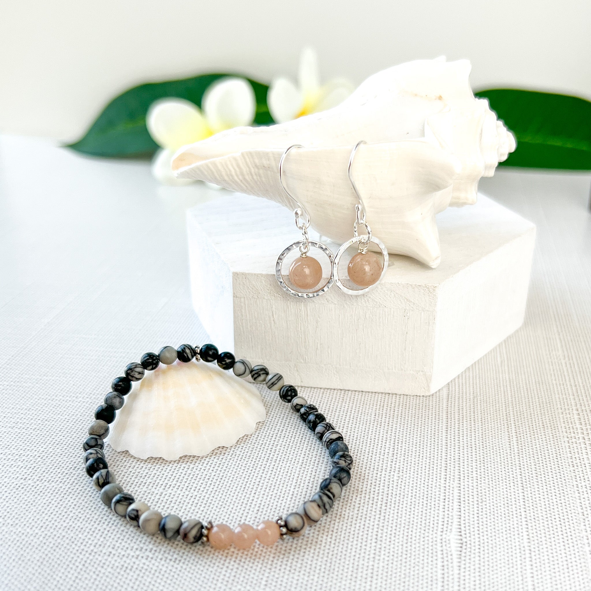 The subtle pink freckles of these Semi-precious gemstones are stunningly framed by silver circles.  Wear this with the Pink Flake Moonstone and Black Silk Stone bracelet -- a minimal and elegant choice while working at home, or out with your girlfriends for coffee. Handcrafted in California.