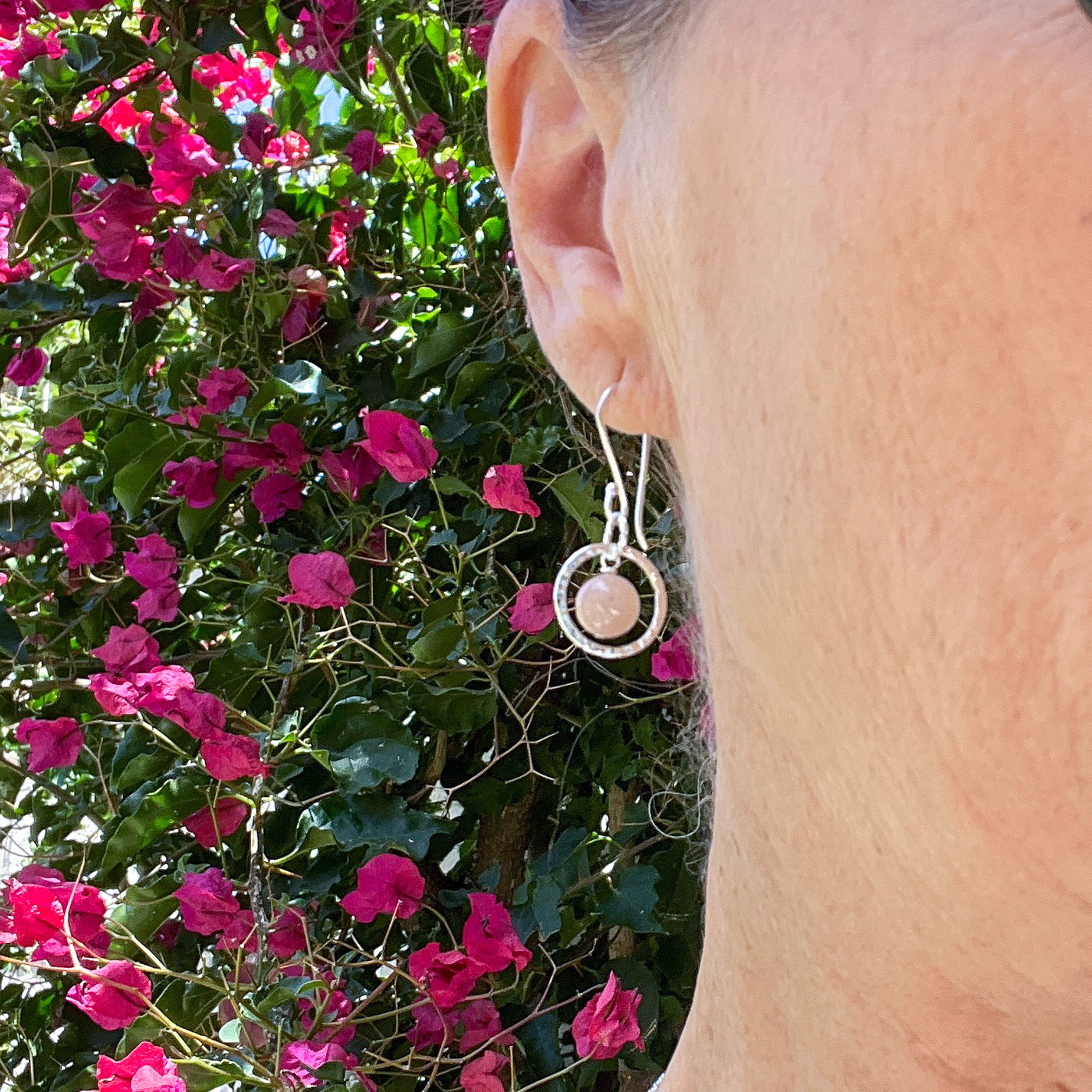 The subtle pink freckles of these Semi-precious gemstones are stunningly framed by silver circles.  Part of the Novaura Jewelry Sparkle Sets. Handcrafted in California. Shown on model.