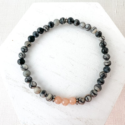 The lovely subtle pink of the moonstone contrasts nicely with the natural black silk stone and silver spacer beads. Part of the Novaura Jewelry Sparkle Set.