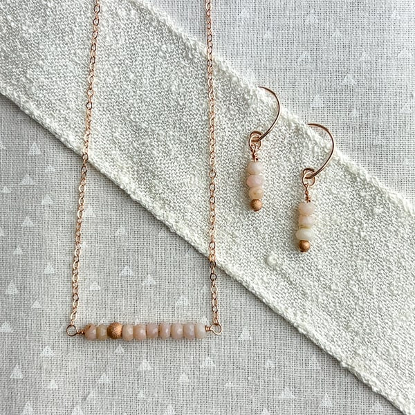 Delicate Pink Opal gemstone and Rose Gold-filled bar necklace.  The shine of the Rose Gold stardust bead compliments the opals nicely and gives the necklace an air of sophistication. Perfect alone or for layering. Dainty Pink Opal gemstone and Rose Gold-filled Earrings.  An easy-wearing earring for a casual or dressy outfit. 