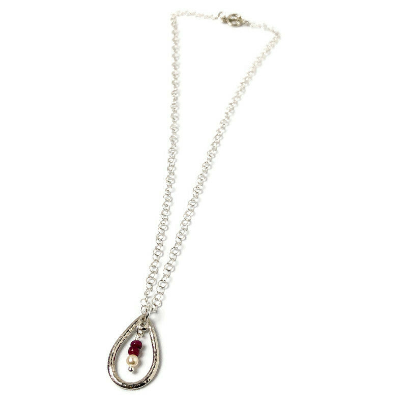 Delicate hammered finish for incredible texture to give a vintage flair to the open teardrop pendant. Genuine Rubys-the queen of gems in a well-polished deep red and hand-cut rondelle shape. Swarovski crystal pearl to complement the ruby red of the gems. Lightweight pendant in rhodium-plated pewter. Handcrafted in CA.