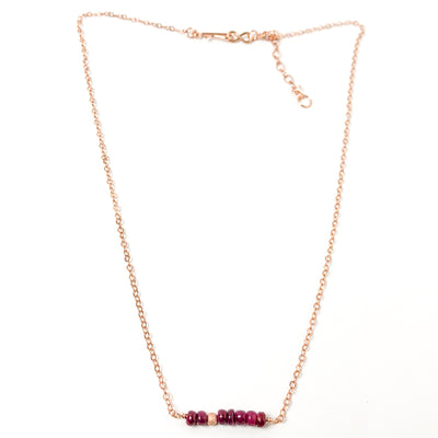 Delicate genuine Ruby gemstone and 14Kt Rose Gold-filled bar necklace. Perfect alone or for layering. The shine of the Rose Gold stardust bead compliments the red rubies nicely and gives the necklace an air of sophistication. The queen of gems in a well-polished deep red and hand-cut rondelle shape. Handcrafted in CA Clasp detail