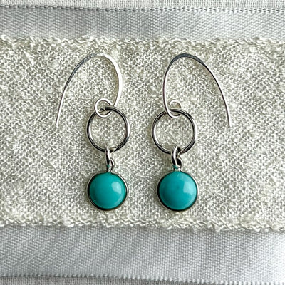 TURQUOISE-- get drawn by its beauty and its positivity - the translucent blue pop of color that makes you feel calm, relaxed, and happy. Sterling silver circle accentuates these stunning earrings to wear alone or with your favorite sterling necklace.