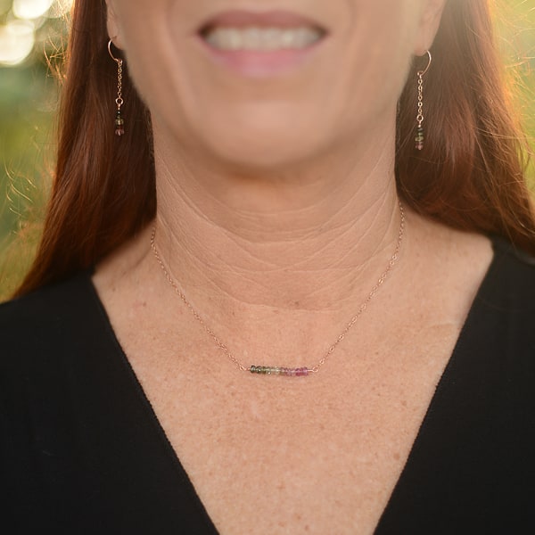 This tourmaline bar necklace is sure to tantalize with its enchanting pink and green Tourmaline gems. Crafted with a 14Kt rose-gold chain, the necklace sits lovingly on your neck. Add a touch of subtle glamour to any look with this sophisticated necklace. Pair with delicate earrings to express your minimalist look. Shown worn with matching Tourmaline earrings.
