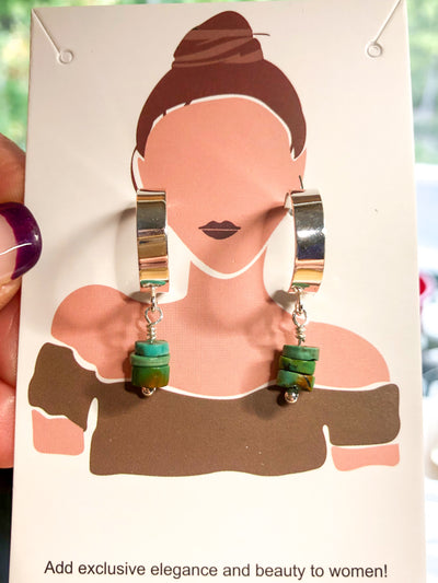 TURQUOISE-- get drawn by its beauty and its positivity - the small sea-green heishi beads create a color pop to these sterling silver half hoop ear studs. 