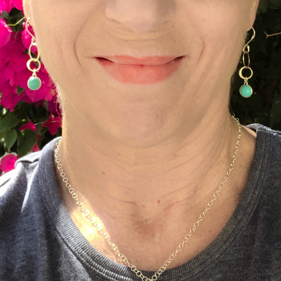 TURQUOISE-- get drawn by its beauty and its positivity - the translucent blue pop of color that makes you feel calm, relaxed, and happy. Intertwining sterling silver CIRCLES OF LIFE accentuates these stunning earrings to wear alone or with your favorite sterling necklace. Modeled by Laura